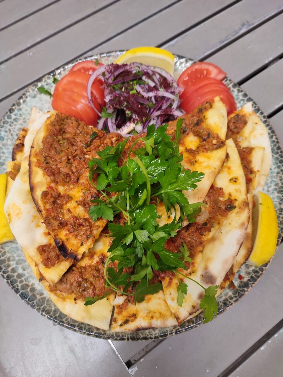 Thin flatbread with spiced lamb, herbs and lemon